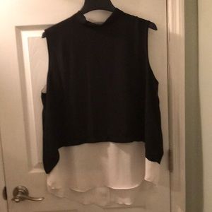 Black and white flowing sleeveless top.